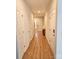 Well-lit hallway with wood flooring and multiple doors, leading to various rooms in the home at 320 Lawrence Gray Rd, Charlotte, NC 28262