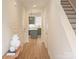 Inviting hallway with hardwood floors leading to a kitchen with gray cabinets and a kitchen island at 320 Lawrence Gray Rd, Charlotte, NC 28262