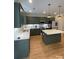 Modern kitchen with green cabinets, quartz countertops, stainless steel appliances, and a center island at 320 Lawrence Gray Rd, Charlotte, NC 28262