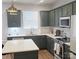 Well-lit kitchen featuring green cabinets, white countertops, modern appliances, and stylish fixtures at 320 Lawrence Gray Rd, Charlotte, NC 28262