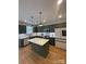 Bright kitchen with green cabinets, white countertops, stainless steel appliances, and a center island at 320 Lawrence Gray Rd, Charlotte, NC 28262