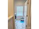 Charming laundry room with patterned tile floors, window with blinds and storage at 320 Lawrence Gray Rd, Charlotte, NC 28262