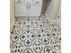 Stylish laundry room with decorative tiled floor and white cabinetry at 320 Lawrence Gray Rd, Charlotte, NC 28262