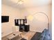 Living room with a TV, desk, sofa, floor lamp, and neutral carpeting at 320 Lawrence Gray Rd, Charlotte, NC 28262