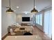 Open-concept living and dining area with stylish decor, modern lighting, and comfortable seating at 320 Lawrence Gray Rd, Charlotte, NC 28262