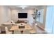 Bright and airy living room featuring an L-shaped couch, large windows, modern decor, and wood-style floors at 320 Lawrence Gray Rd, Charlotte, NC 28262