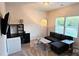 Living room area featuring couch, soft carpet, lighting and a tv at 320 Lawrence Gray Rd, Charlotte, NC 28262
