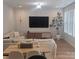 Cozy living room showcasing modern furniture, a large TV, and elegant wall paneling at 320 Lawrence Gray Rd, Charlotte, NC 28262