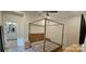Bright main bedroom featuring a four poster bed, ceiling fan and an ensuite bathroom with double sinks at 320 Lawrence Gray Rd, Charlotte, NC 28262