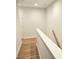 A minimalist staircase featuring hardwood floors with white trim at 320 Lawrence Gray Rd, Charlotte, NC 28262