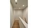 Narrow stairwell featuring wood-style floors, white walls, and recessed lighting, perfect for a modern home at 320 Lawrence Gray Rd, Charlotte, NC 28262