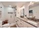 The bright bathroom offers double sinks, granite counters, a glass enclosed shower with a built in niche at 3214 Tilley Morris Rd, Matthews, NC 28105