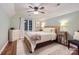 This charming bedroom is complete with a woven bed frame, rustic dresser, and soft natural light at 3214 Tilley Morris Rd, Matthews, NC 28105