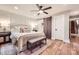 Serene main bedroom features soft lighting, a cozy rug, and a unique sliding barn door at 3214 Tilley Morris Rd, Matthews, NC 28105