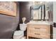 Stylish powder room with wood paneled walls, modern fixtures, and a clean, contemporary design at 3214 Tilley Morris Rd, Matthews, NC 28105