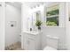 Bright bathroom featuring white subway tile shower and modern vanity with gray and white patterned tile floor at 4017 Sulkirk Rd, Charlotte, NC 28210