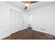 Bedroom with hardwood floors, closet, and ceiling fan at 4017 Sulkirk Rd, Charlotte, NC 28210