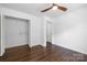 Bright bedroom with hardwood floors, ceiling fan, and closet at 4017 Sulkirk Rd, Charlotte, NC 28210