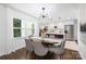 Elegant dining room with modern light fixture and views into the kitchen at 4017 Sulkirk Rd, Charlotte, NC 28210