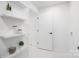 Hallway featuring marble floors, decorative shelves, and doorway at 4017 Sulkirk Rd, Charlotte, NC 28210