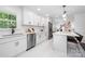 Bright, updated kitchen with white cabinets, quartz countertops and stainless appliances at 4017 Sulkirk Rd, Charlotte, NC 28210