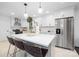 Modern white kitchen with stainless steel appliances and a large center island at 4017 Sulkirk Rd, Charlotte, NC 28210