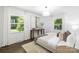 Inviting main bedroom featuring two large windows and neutral decor at 4017 Sulkirk Rd, Charlotte, NC 28210