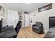 Bedroom offers a comfortable gray armchair, laminate floors and fresh paint at 403 W 2Nd St, Cherryville, NC 28021