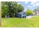 Charming home featuring a fresh blue exterior, green lawn, and convenient storage shed at 403 W 2Nd St, Cherryville, NC 28021