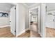 Hallway provides an open view of a bedroom with laminate flooring and gray walls at 403 W 2Nd St, Cherryville, NC 28021