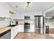 Charming kitchen with white cabinets, butcher block counters, stainless steel appliances and modern lighting fixture at 403 W 2Nd St, Cherryville, NC 28021