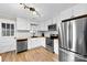 Well-lit kitchen featuring white cabinets, stainless steel appliances, butcher block counters and sleek subway tile backsplash at 403 W 2Nd St, Cherryville, NC 28021