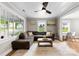 Comfortable living room with a large sofa, natural light, and ceiling fan at 403 W 2Nd St, Cherryville, NC 28021