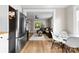 Open concept living room and kitchen with stainless steel refrigerator and dining area with lots of natural light at 403 W 2Nd St, Cherryville, NC 28021