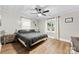 Main bedroom featuring ceiling fan, two side tables and laminate flooring and a bright window at 403 W 2Nd St, Cherryville, NC 28021