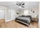 Bedroom featuring ceiling fan, two side tables, laminate flooring and an adjacent door at 403 W 2Nd St, Cherryville, NC 28021