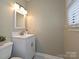 Half bathroom featuring a modern vanity with a sink and mirror plus stylish lighting at 407 S Buckoak St, Stanley, NC 28164