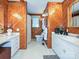 Unique bathroom featuring wood paneling, dual sinks, and plenty of storage at 407 S Buckoak St, Stanley, NC 28164