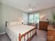 Sunny bedroom with a comfy bed, dresser, and bright windows at 407 S Buckoak St, Stanley, NC 28164
