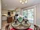 Inviting eat-in kitchen with a glass-top table set for four adjacent to the kitchen area and a sliding glass door at 407 S Buckoak St, Stanley, NC 28164