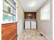 Functional laundry room featuring a washer, dryer, and overhead storage cabinets at 407 S Buckoak St, Stanley, NC 28164