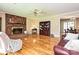 Hardwood floors and a brick fireplace highlight this living room adjacent to the dining room at 407 S Buckoak St, Stanley, NC 28164