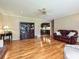 Open-concept living space featuring gleaming hardwood floors and a glimpse into an adjacent kitchen at 407 S Buckoak St, Stanley, NC 28164