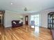 Bright living room with hardwood floors, complemented by a decorative ceiling fan, and a view of the entrance at 407 S Buckoak St, Stanley, NC 28164