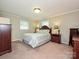 Comfortable main bedroom with a queen-sized bed and coordinating furniture at 407 S Buckoak St, Stanley, NC 28164