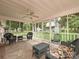 Inviting screened-in patio featuring comfortable seating and serene views of the landscaped backyard at 407 S Buckoak St, Stanley, NC 28164