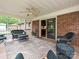 Relaxing screened-in patio with ceiling fan, brick accents, and sliding door access to the home interior at 407 S Buckoak St, Stanley, NC 28164