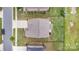 A bird's-eye view of a home with a well-maintained lawn, landscaping, and a driveway at 463 Hunton Forest Nw Dr, Concord, NC 28027