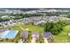 Aerial view of a community with a pool and common green space, featuring diverse home exteriors at 463 Hunton Forest Nw Dr, Concord, NC 28027