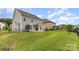 A view of the backyard, highlighting the fence, lawn, and the house's exterior at 463 Hunton Forest Nw Dr, Concord, NC 28027